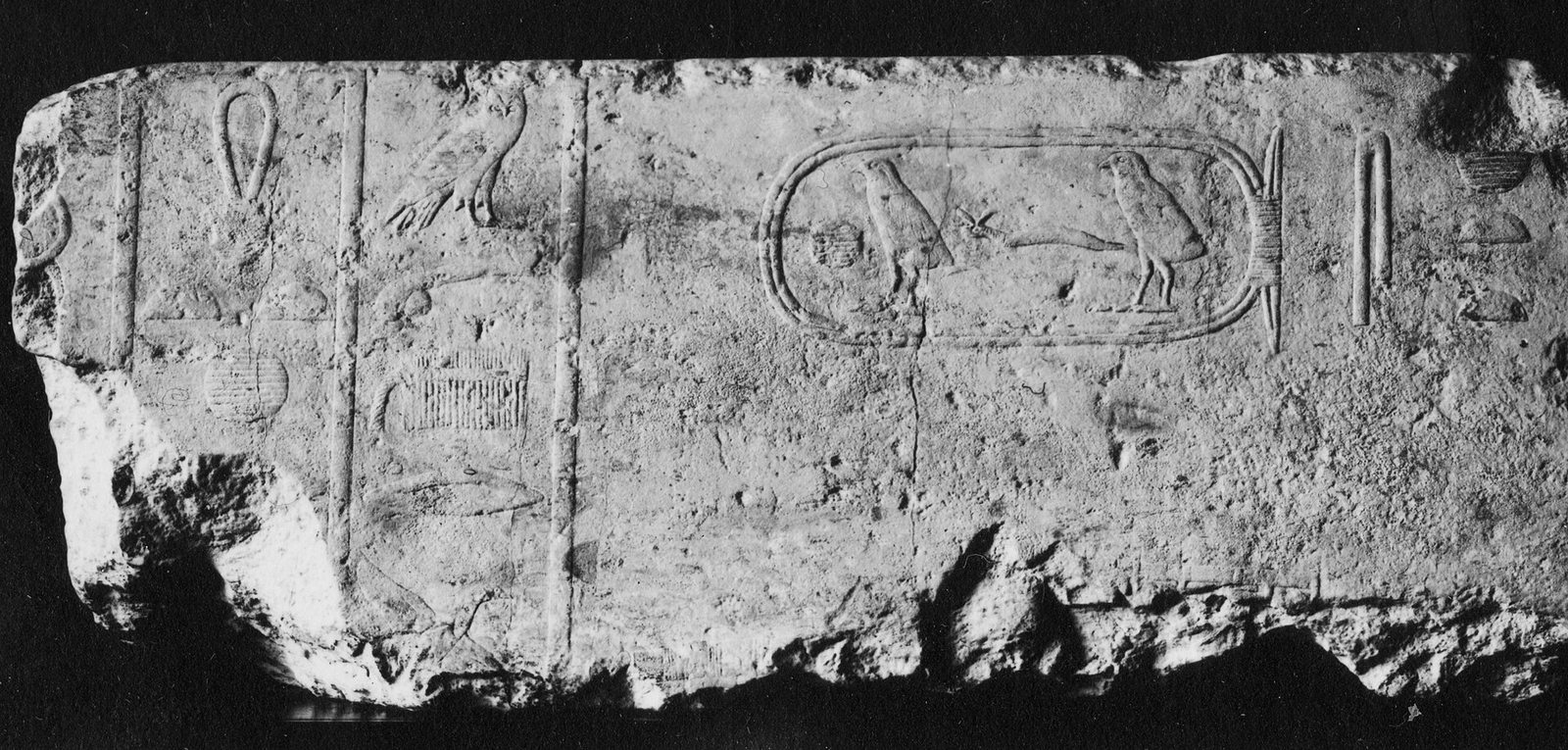 Carved Egyptian relief block with figures and signs